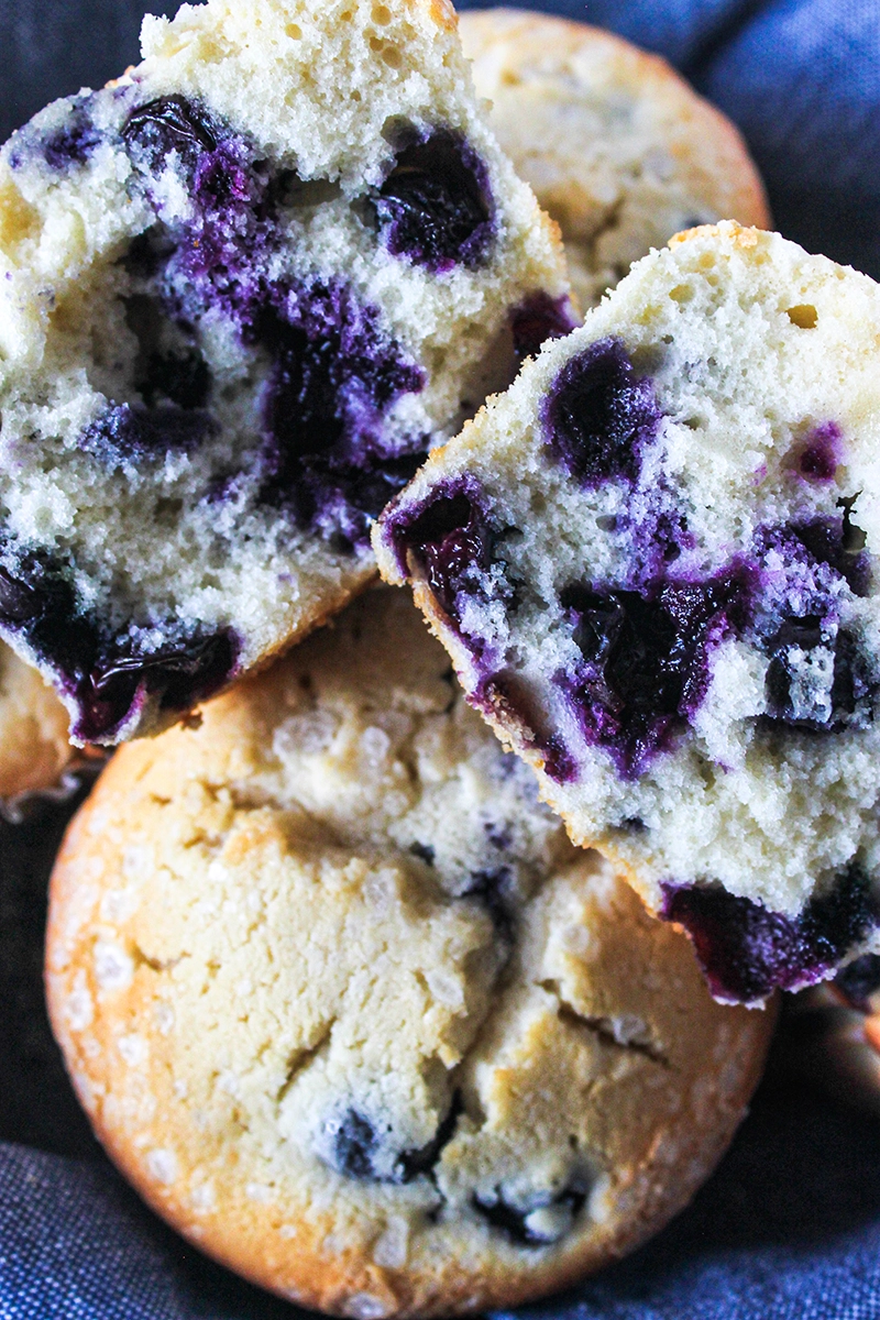 Small batch blueberry muffins with a bite taken out of them.